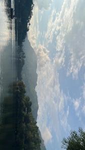a view of a mountain with clouds in the sky at Bhimtaal cottages in Bhīm Tāl +8 photos