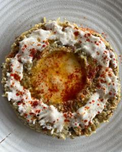 a pastry on a white plate with white icing at Bhimtaal cottages in Bhīm Tāl