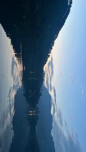 a reflection of the sky and clouds in the water at Bhimtaal cottages in Bhīm Tāl