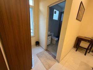 a bathroom with a toilet and a mirror at The Annexe in Greater Noida
