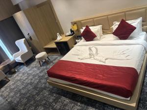 a hotel room with a bed with a bow on it at The Chinmaye Grand in Bhāgalpur