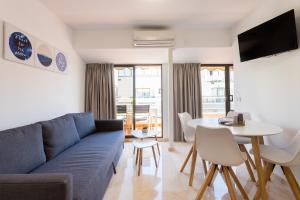 a living room with a blue couch and a table at Apartamentos Edf AUREA y Edf SARVACHO in Benidorm