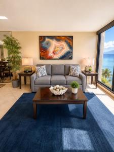 a living room with a couch and a table at Mahana 604 Oceanfront 1BD 1BA condo in Kahana