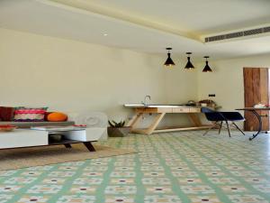 a living room with a couch and a table at DanCenter Parijat Villas & Suites Udaipur in Udaipur +63 photos