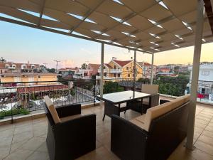 a patio with a table and chairs on a balcony at Grouzi Residences in Skala