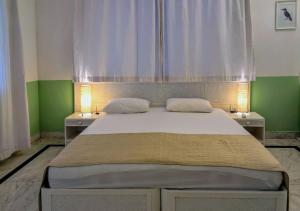a bedroom with a large bed with two night stands at Beach villa Candolim in Candolim