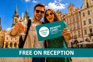 a man and woman holding a sign in front of a building at Metropolitan Old Town Hotel - Czech Leading Hotels in Prague