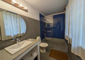 a bathroom with a sink and a toilet and a shower at Beach villa Candolim in Candolim +33 photos