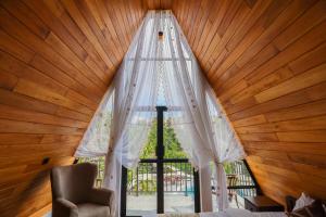 a room with a large window with a white curtain at The Glade in Weligama