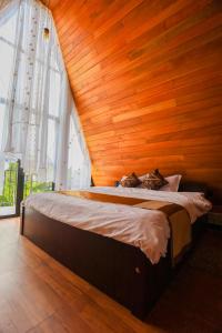 a bed in a room with a wooden wall at The Glade in Weligama +108 photos