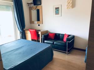 a bedroom with a bed and a couch at Hotel Grotte in Mongiove