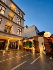 a large building with potted plants in a courtyard at Wisma Pelangi 1 in Jakarta