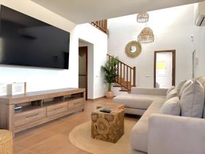 a living room with a large flat screen tv at Villa Can Alaya in Santa Eularia des Riu