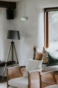 a living room with a couch and chairs and a lamp at Kanuka Terrace - Luxury Strawbale House in Kaikoura