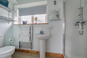 a bathroom with a sink and a toilet and a shower at Ashclose Lodge Annexe in Sherborne