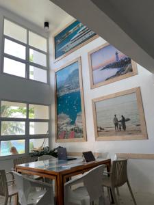 a dining room with a table and some pictures on the wall at Dapdap Shorelines Beachfront Villa in Camotes Islands