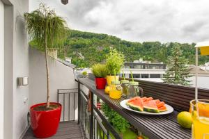 a balcony with a plate of watermelon and fruit at Salzburg Apartments in Salzburg