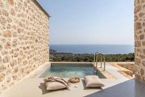 a swimming pool with a view of the ocean at Eks Mani Peninsula Retreat in Pirgos
