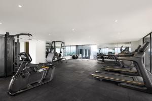a gym with treadmills and ellipticals in a room at Oakwood Yogyakarta in Yogyakarta
