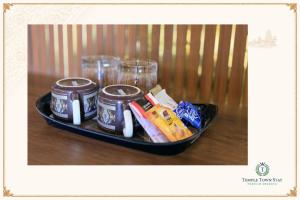 a tray of food and drinks on a table at Temple Town Stay in Kanchipuram