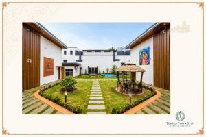 a building with a garden and a gazebo at Temple Town Stay in Kanchipuram