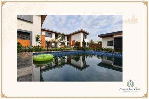 a swimming pool in front of a house at Temple Town Stay in Kanchipuram
