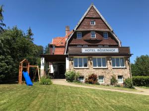 a house with a playground in front of it at Harzlodge Lebenstraum in Braunlage