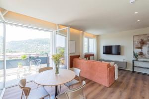 a living room with a table and a large window at The Circle Bike Residence by Rent All Como in Tavernerio