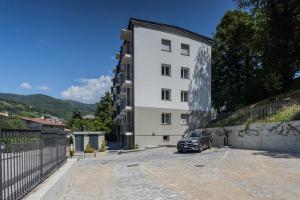 a car parked in front of a white building at The Circle Bike Residence by Rent All Como in Tavernerio