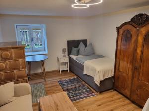 a bedroom with a bed and a table and a couch at Ferienhaus Vitabene in Hollenstein an der Ybbs +8 photos