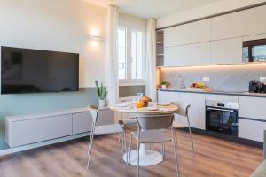 a kitchen with a table and chairs in a room at The Circle Bike Residence by Rent All Como in Tavernerio