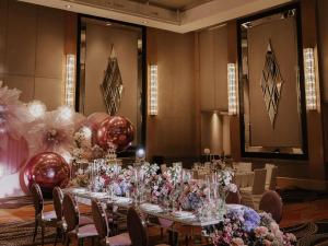 a dining room with a long table with flowers at Fairmont Makati in Manila +164 photos
