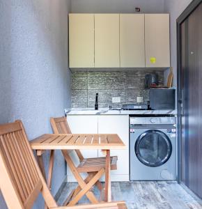 a kitchen with a table and a washing machine at Muros Guesthouse in Mestia