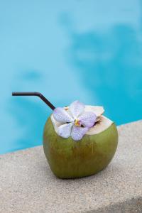 a green apple with a flower on top of it at The Beach Wellness Residence in Ban Pru Yai