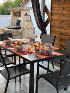 a black table with food on it on a patio at Les gîtes du Chemin Le Compostelle in Paray-le-Monial