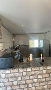 a kitchen with a sink and a counter top at Appartement proche mer  +4 photos
