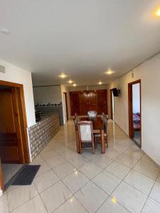 a dining room and kitchen with a table and chairs at Appartement proche mer 