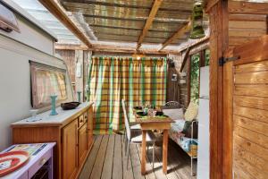 a kitchen with a table and a dining room at Caravane au jardin in Brix