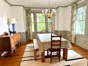 a dining room with a table and chairs and a desk at Camden at Monticello in Salisbury