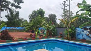 a house with a swimming pool in a yard at Escape Villa - Kilimanjaro in Moshi