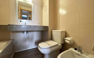 a bathroom with a white toilet and a sink at Miquel 2 – Apartamento con Parking, Wifi y A/C in Tossa de Mar +37 photos