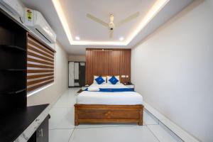 a bedroom with a bed and a ceiling at BREEZA GRANd in Kazhakuttam