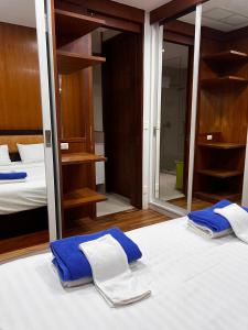 two towels on a bed in a room with a mirror at Q Kata Residence in Kata Beach