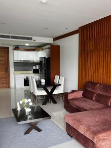 a living room with a couch and a table at Q Kata Residence in Kata Beach +226 photos