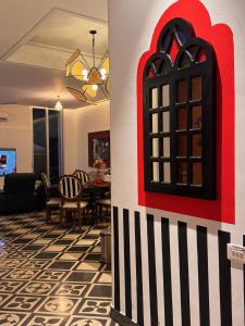 a living room with a red and white wall at Big Pvt Pool & Garden 3BHK Villa, Morjim Beach 10-14mts in Siolim