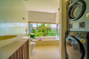 a bathroom with a washing machine and a window at Camfusion Hoi An in Hoi An