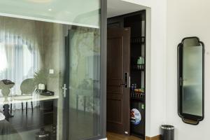 a glass door to a bathroom with a sink at PG indochine Mộc Châu in Sơn La +51 photos