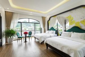 a hotel room with two beds and a balcony at PG indochine Mộc Châu in Sơn La