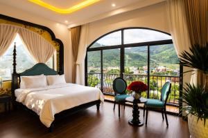 a bedroom with a bed and a large window at PG indochine Mộc Châu in Sơn La
