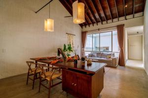 a kitchen with a desk and a living room at Camfusion Hoi An in Hoi An